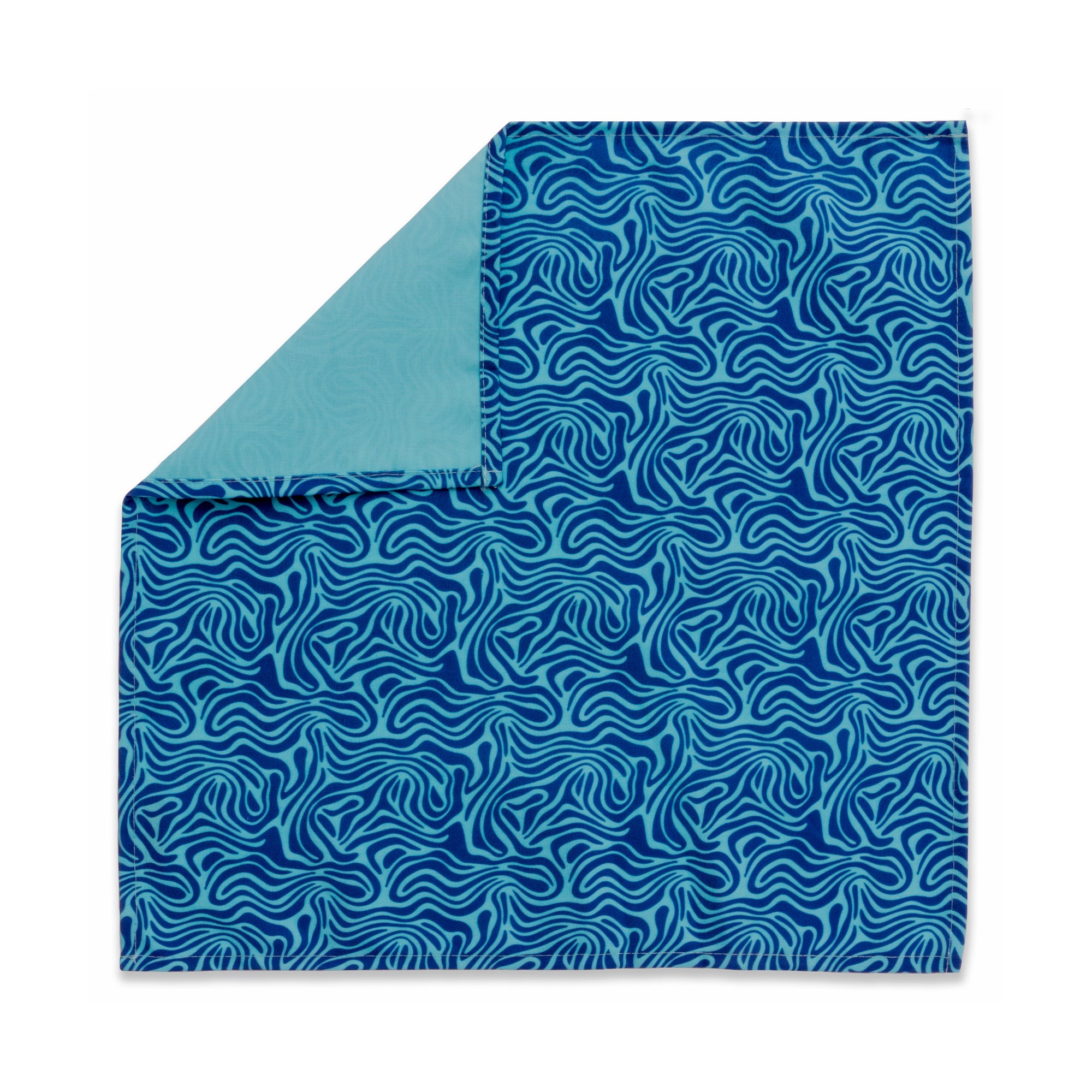 Bright patterned cloth napkin with quarter-inch hem. Base color is sky blue with amorphous layers of royal blue. The back is the base color with small, discreet dark grey logo on bottom left-hand side. View: 1 napkin laid flat, with pattern side exposed and top left corner folded down to expose back side.