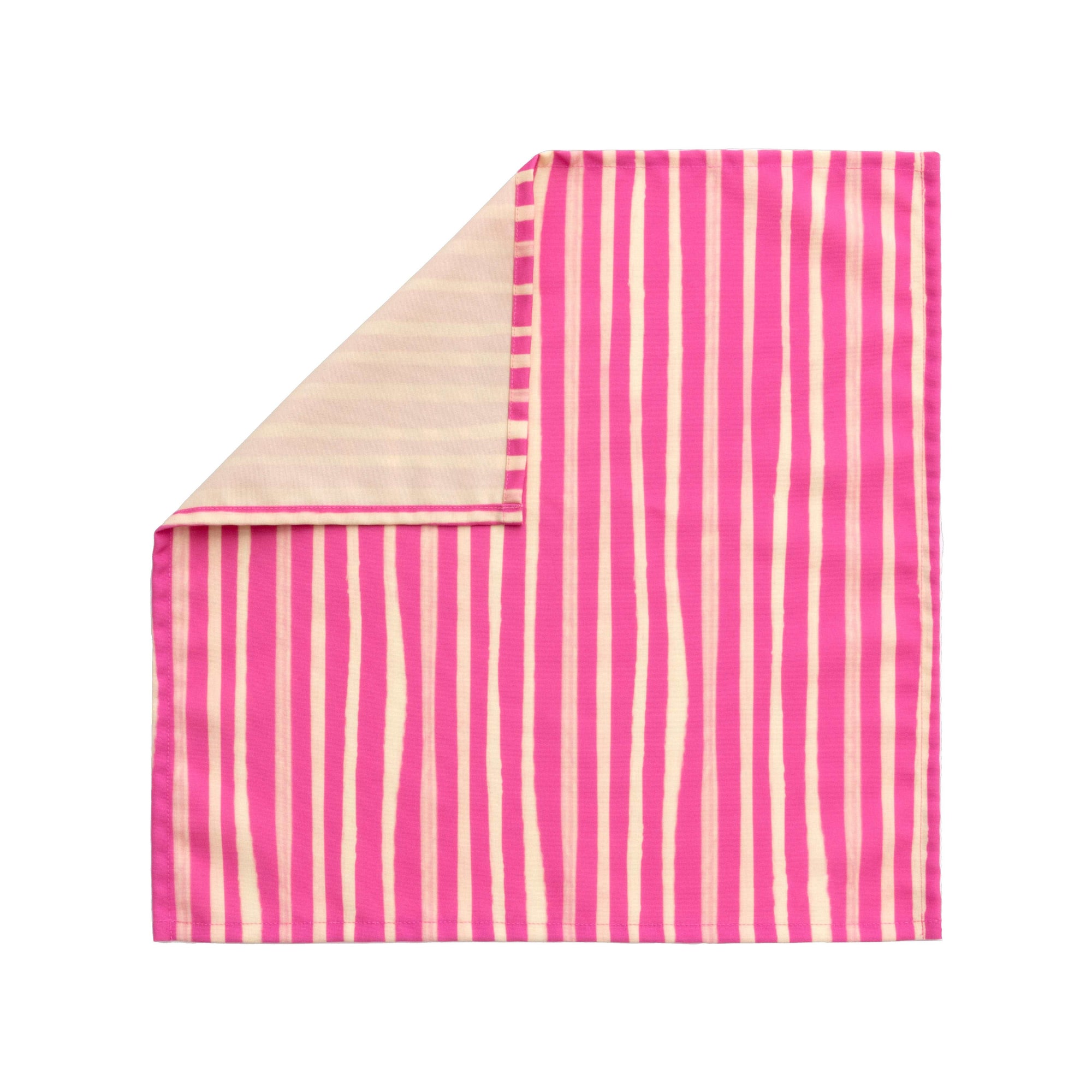 Bright cloth napkin with a pattern of painterly stripes, with quarter-inch hem. Base color is bright magenta, with alternating stripe of cream. The back is the solid base color with small, discreet dark grey logo on bottom left-hand side.  View: 1 napkin laid flat, with pattern side exposed and the top left corner folded down to expose back.