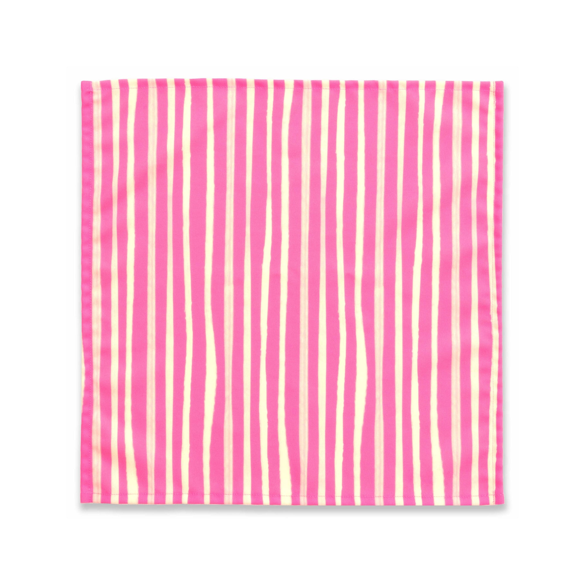 Bright cloth napkin with a pattern of painterly stripes, with quarter-inch hem. Base color is bright magenta, with alternating stripe of cream. The back is the solid base color with small, discreet dark grey logo on bottom left-hand side.  View: 1 napkin laid flat, with pattern side exposed.