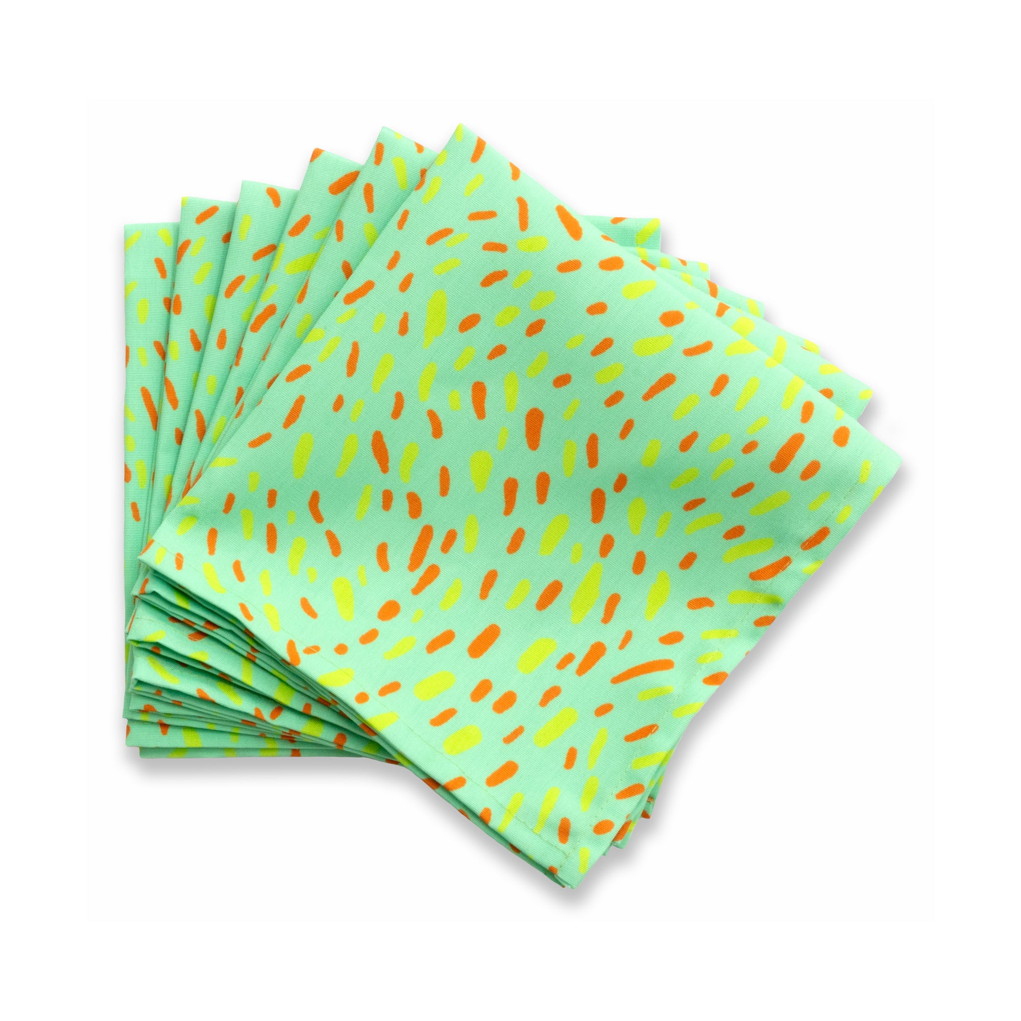 Bright patterned cloth napkin with quarter-inch hem. Base color is light pistachio green with swirling splotches of dark orange and daffodil yellow. The back is the base color with small, discreet dark grey logo on bottom left-hand side. View: 6 napkins folded into quarters and fanned out, with pattern side exposed.