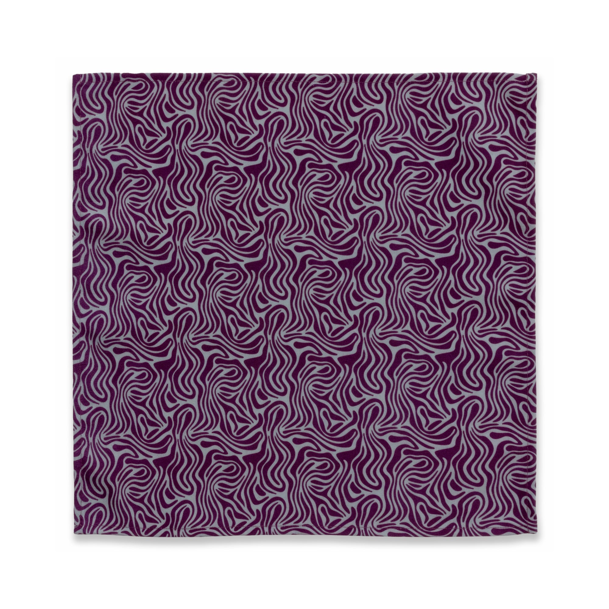 Bright patterned cloth napkin with quarter-inch hem. Base color is stone grey with amorphous layers of dark purple. The back is the base color with small, discreet dark grey logo on bottom left-hand side. View: 1 napkin laid flat, with pattern side exposed.