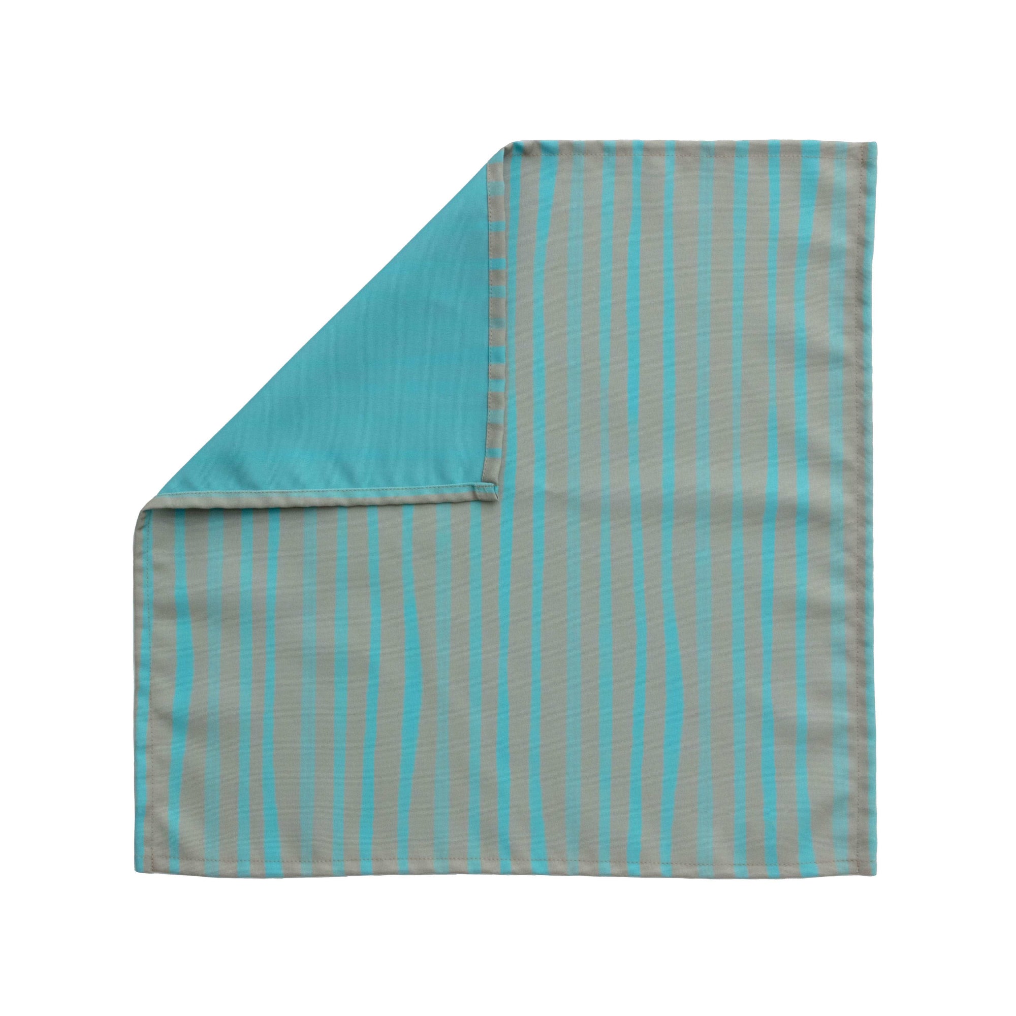 Bright cloth napkin with a pattern of painterly stripes, with quarter-inch hem. Base color is granite grey, with alternating stripe of pastel aquamarine. The back is pastel aquamarine with small, discreet dark grey logo on bottom left-hand side. View: 1 napkin laid flat, with pattern side exposed and the top left corner folded down to expose back side.