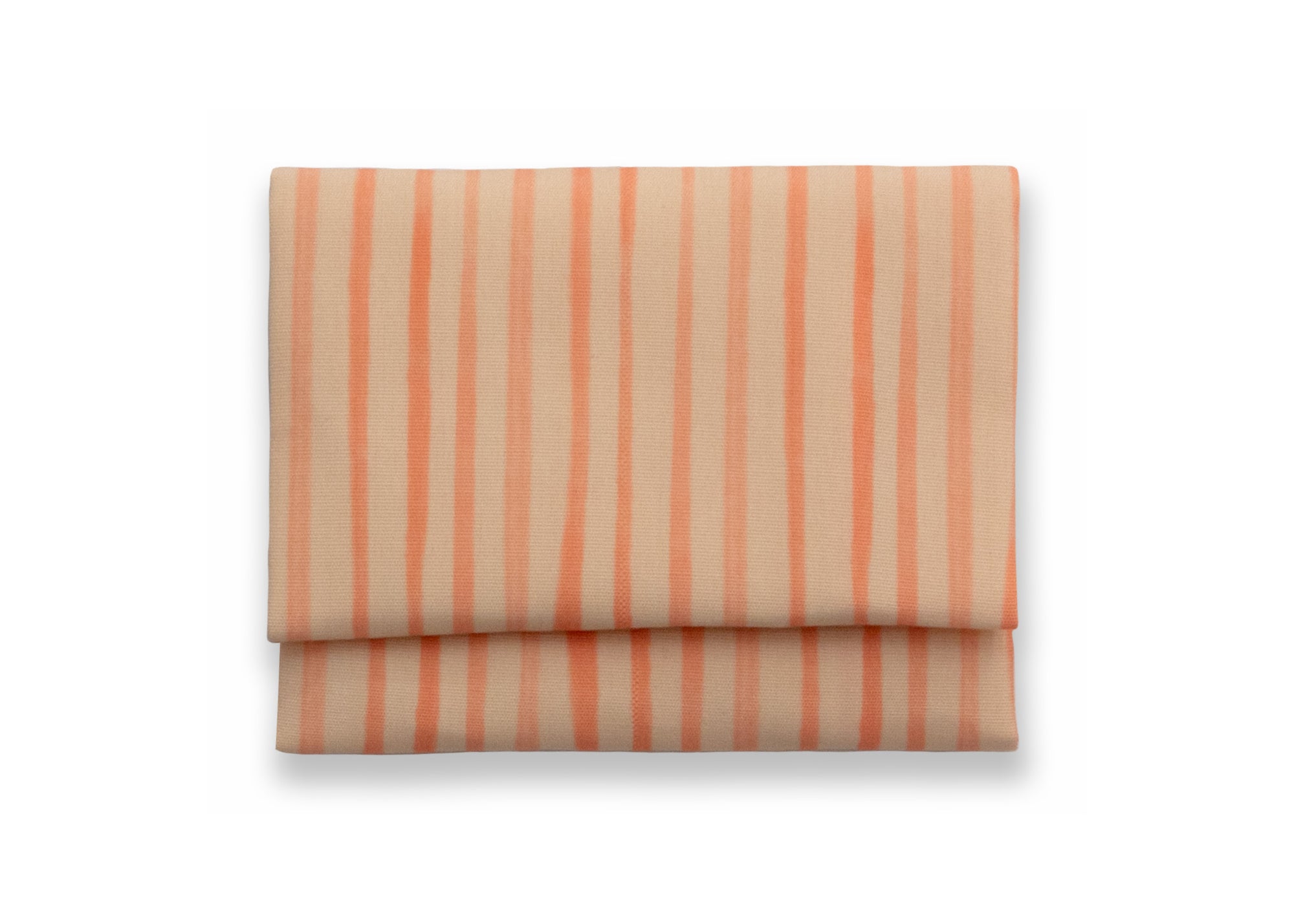 Bright cloth napkin with a pattern of painterly stripes, with quarter-inch hem. Base color is pale apricot with alternating stripe of peach. The back is the base color with small, discreet dark grey logo on bottom left-hand side. View: 1 napkin folded into a rectangular shape for a table setting, with pattern side exposed.